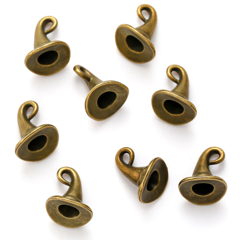 Eight bronze witch hat charms with pointed tops and hanging loops on a white background.