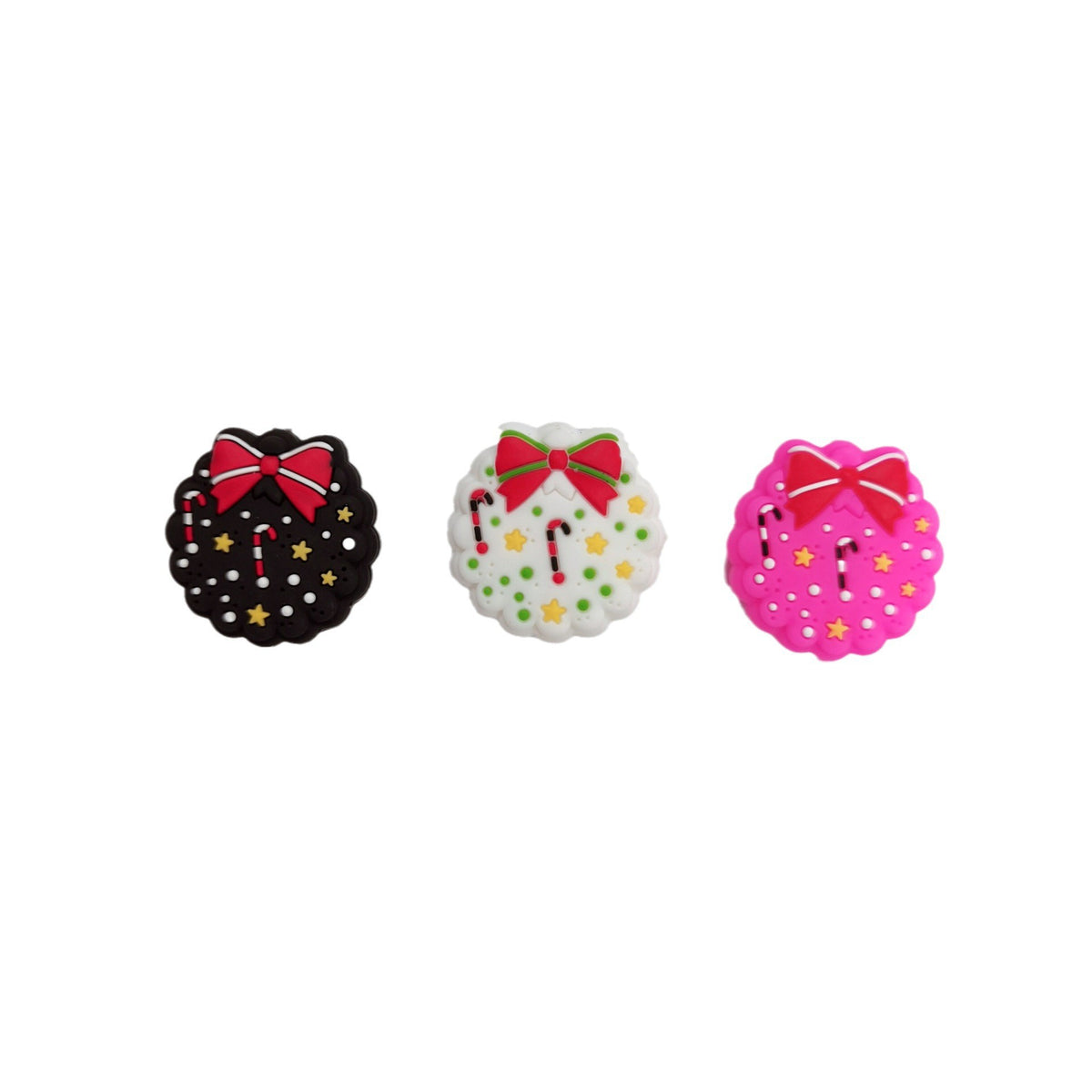Three round Christmas wreath focal beads in black, white, and bright pink, each with red bow, candy canes, and stars.