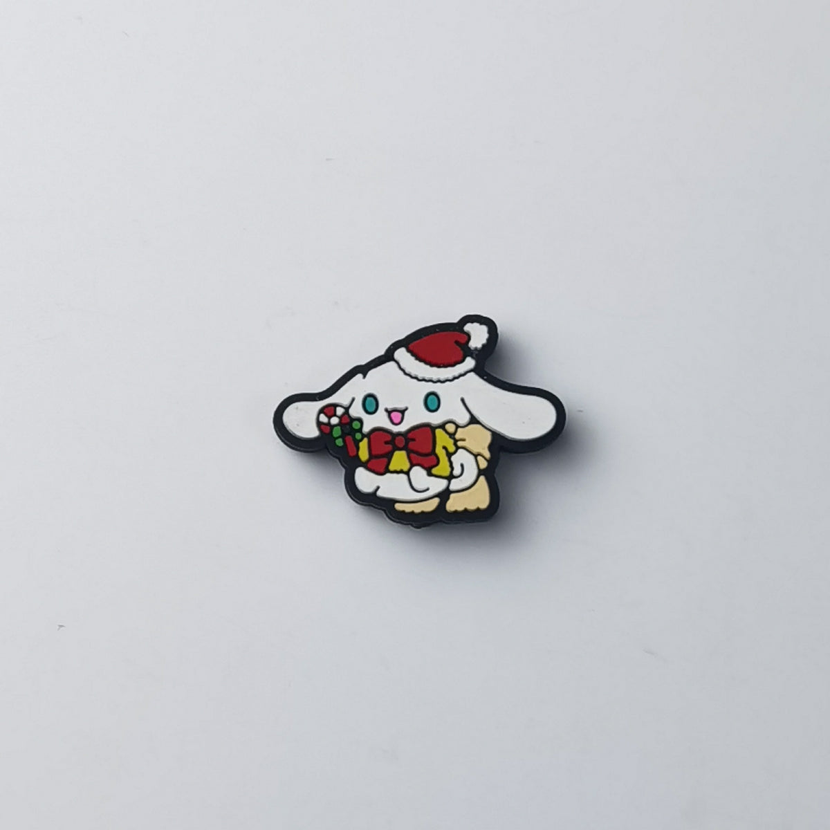 Cinnamoroll silicone focal bead in red Santa hat, holding a gift box with red bow