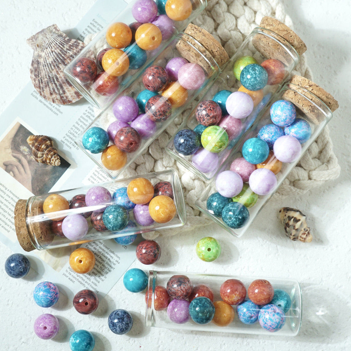 Clear glass vials with cork stoppers filled with colorful marbled round glass beads