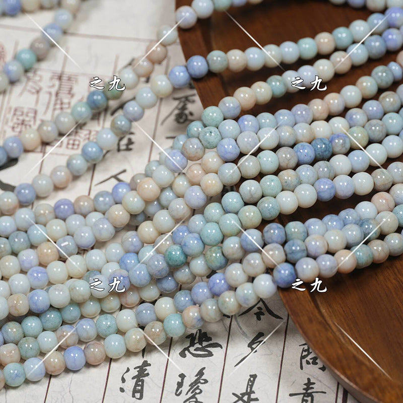 Multiple strands of pastel round porcelain beads in blue, green, beige, white
