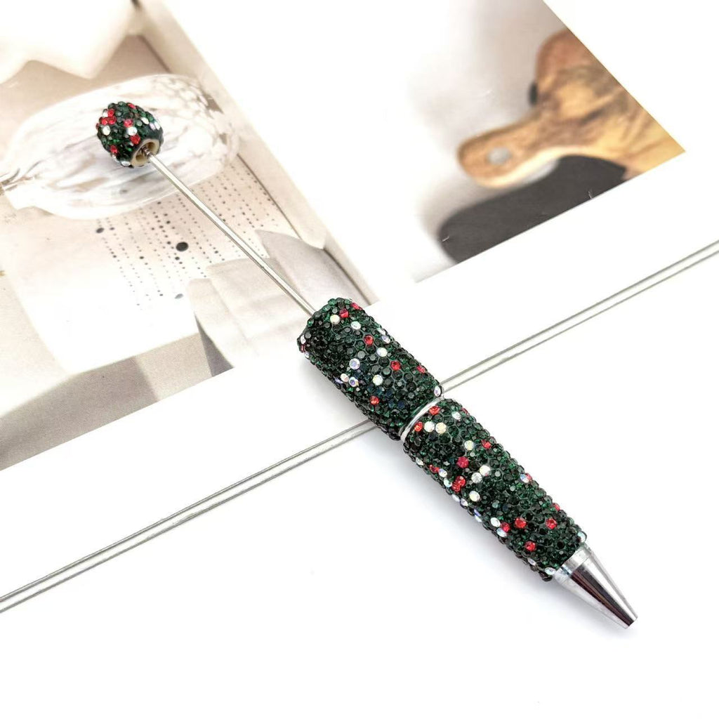 Decorative ballpoint pen with a dark green glittery handle and matching green glittery top