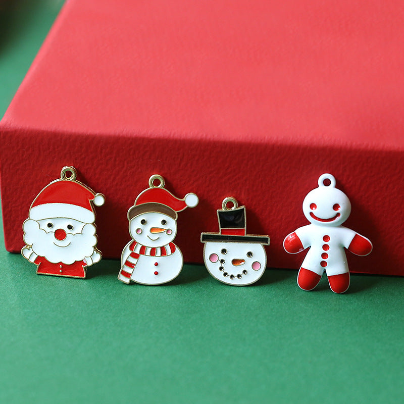 Four Christmas enamel alloy charms: Santa Claus, snowman, snowman face, and gingerbread man