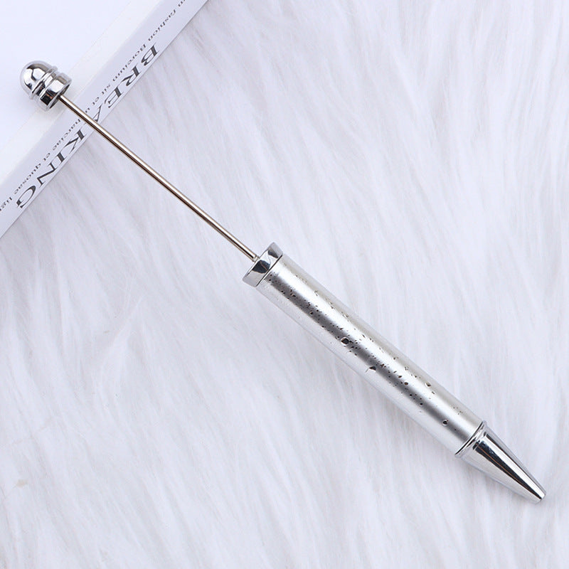 Silver metal beadable pen with long straight rod and rounded end on a white background.