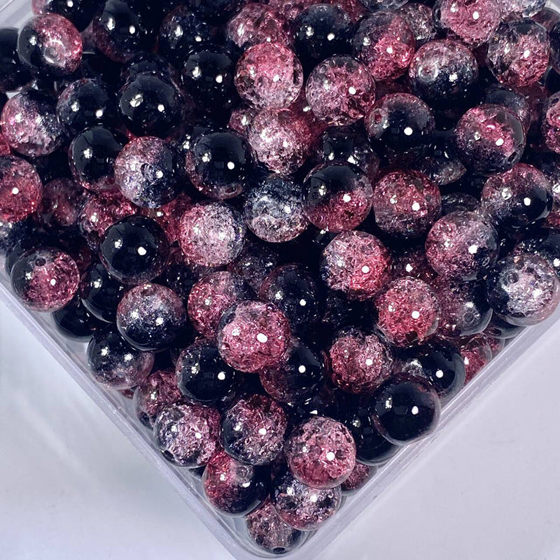 Close-up of black, translucent pink, and glittery pink round glass beads