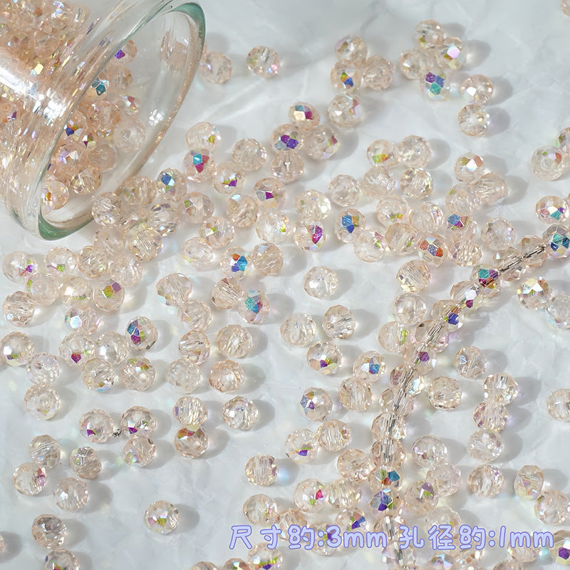 Clear faceted round beads with an iridescent pink and rainbow AB finish, shown spilling from a glass jar onto a white textured surface.