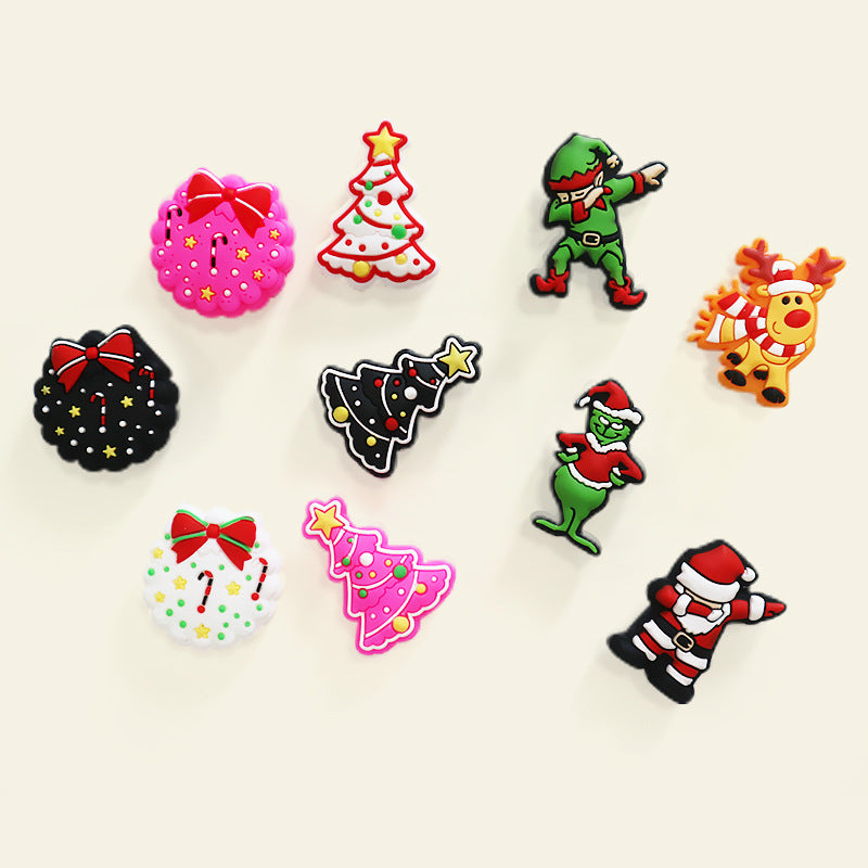 Nine Christmas silicone focal beads scattered: wreaths with red bows, trees, elf, Santa, and reindeer shapes.