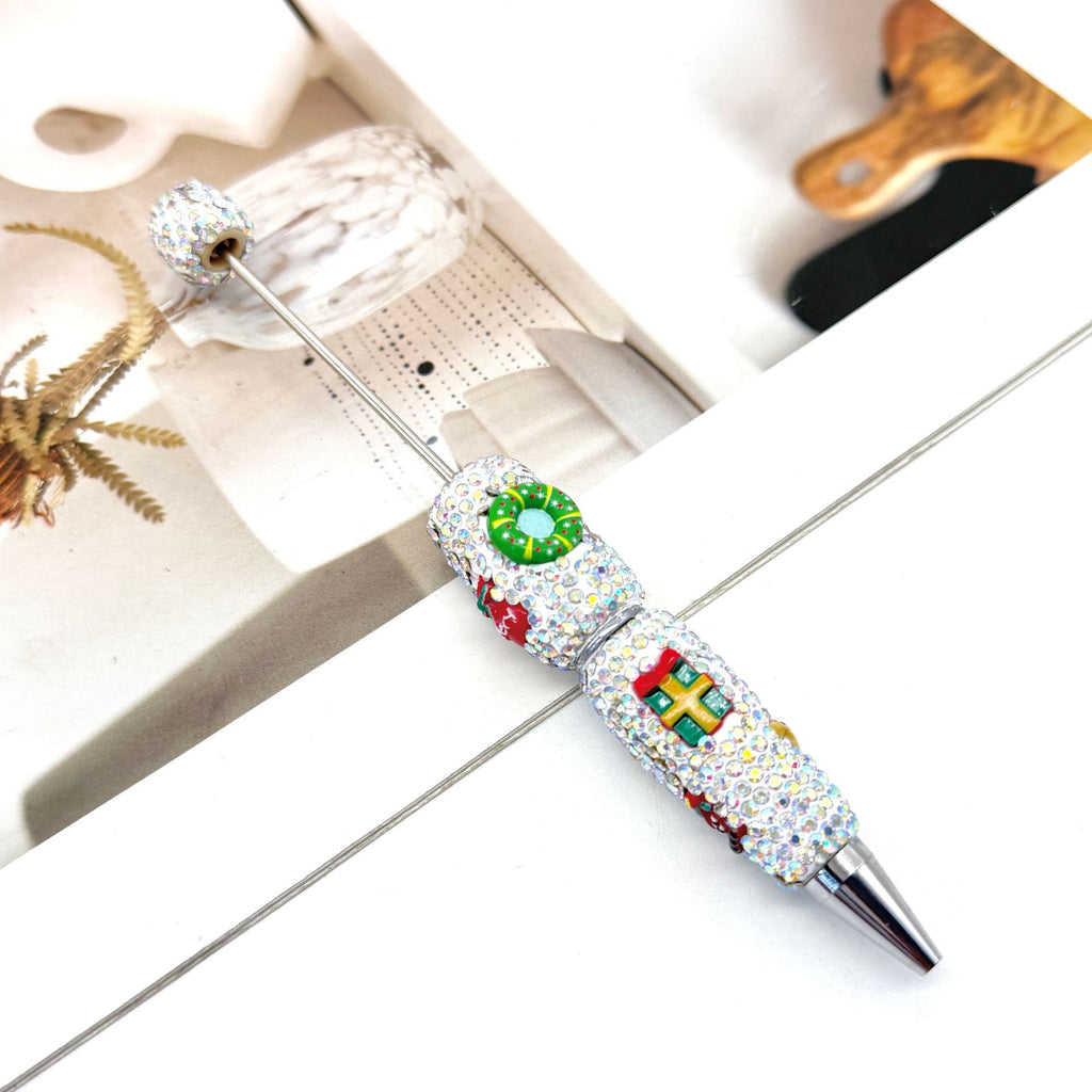 Silver ballpoint pen with clear rhinestones and colorful enamel details.