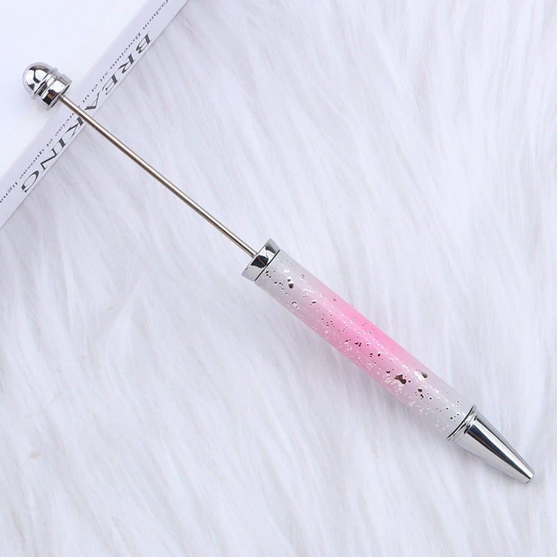 Beadable pen with pink-to-clear glitter gradient handle and silver metal tips.