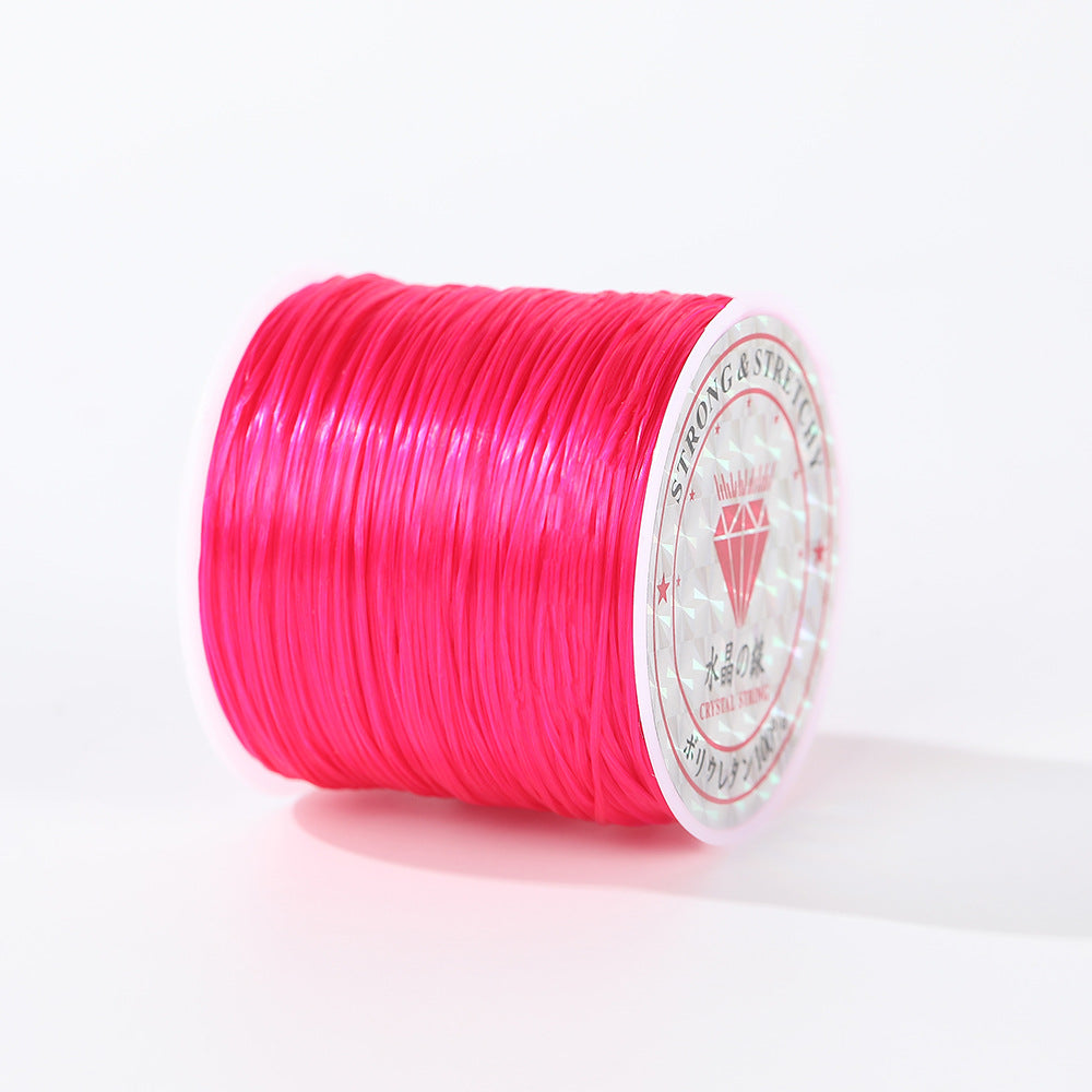 Bright hot pink 0.8mm flat elastic beading cord spool shown at an angle, printed label visible, white background