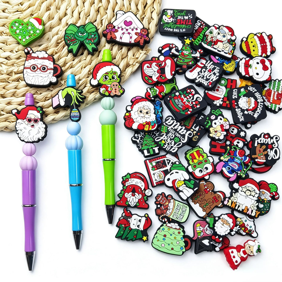 Christmas silicone focal beads and three beadable pens (purple, blue, green) with Santa, Grinch and holiday designs