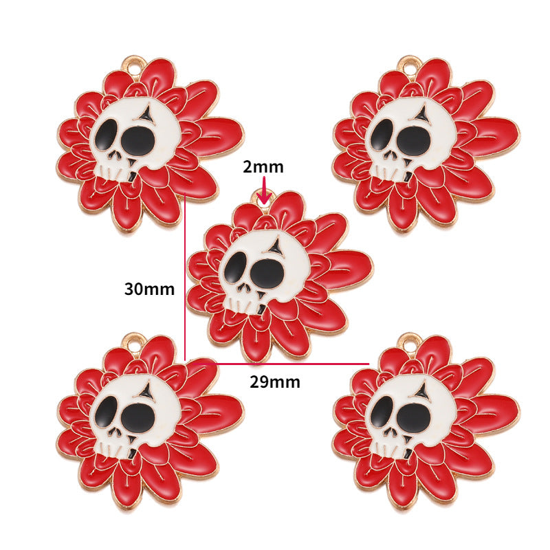 Five red flower-shaped charms with white skull centers and small gold loops