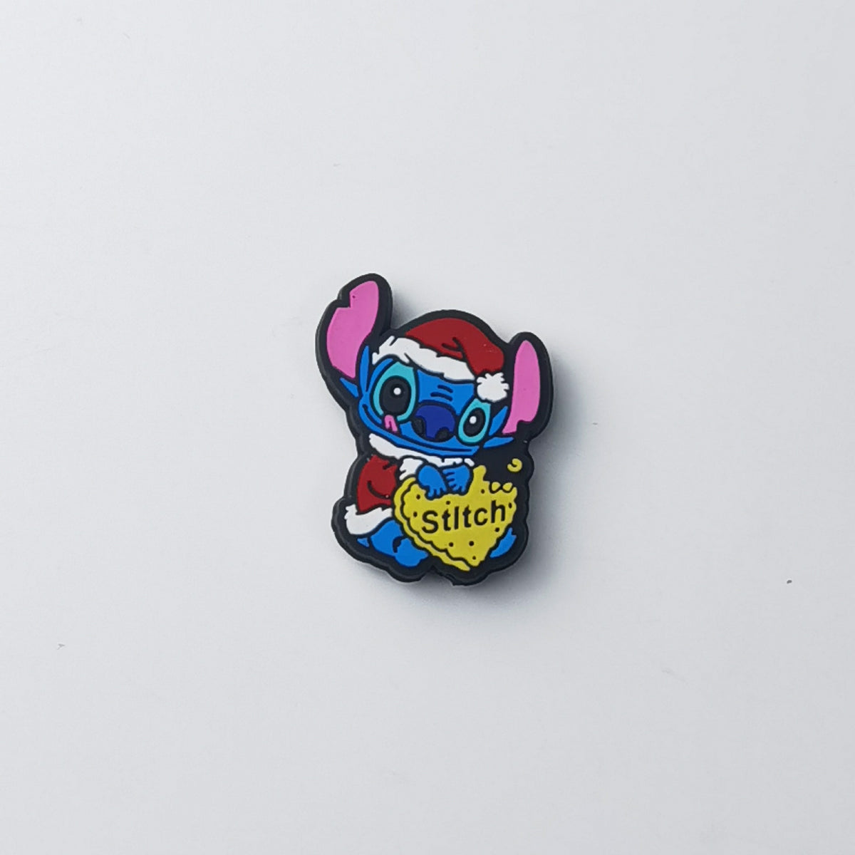 Blue Stitch silicone focal bead in red Santa hat and red outfit, holding yellow heart with 'Stitch' text
