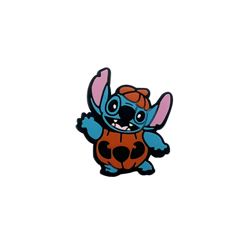 Blue cartoon character wearing an orange pumpkin costume silicone focal bead on white background.