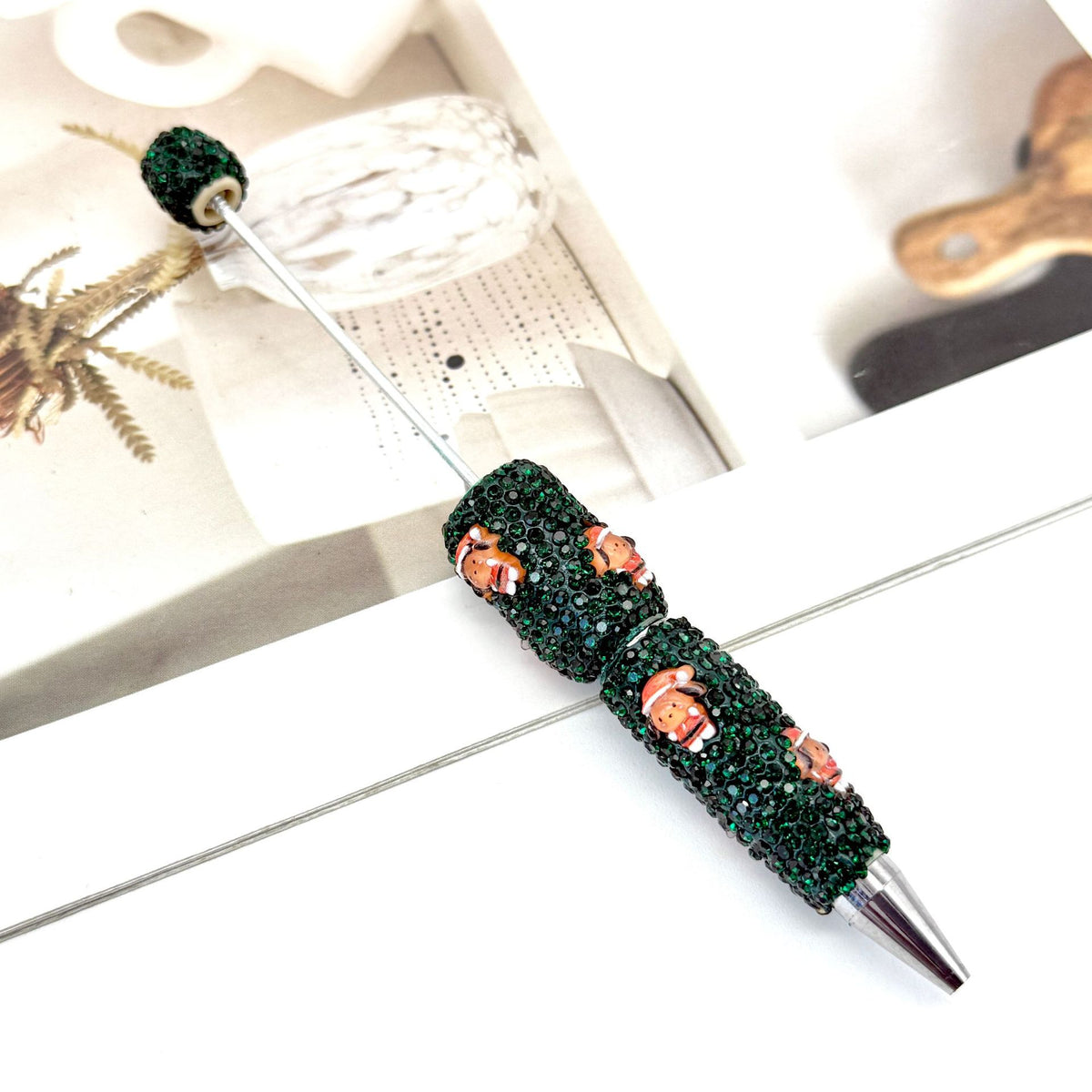 Dark green rhinestone ballpoint pen with matching green spherical top.