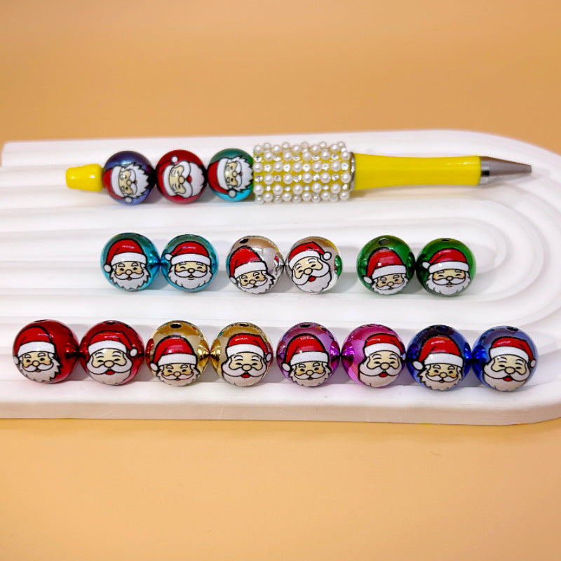 Round acrylic beads with Santa Claus faces in three rows on a tray