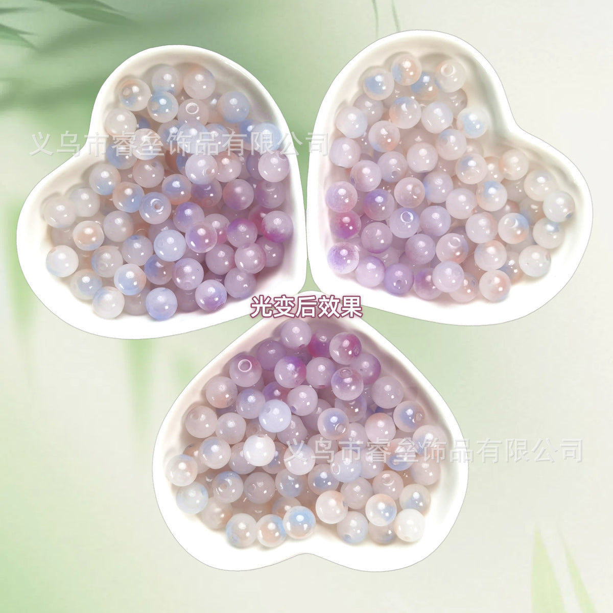 Three heart-shaped bowls of iridescent pastel lavender and pale blue beads