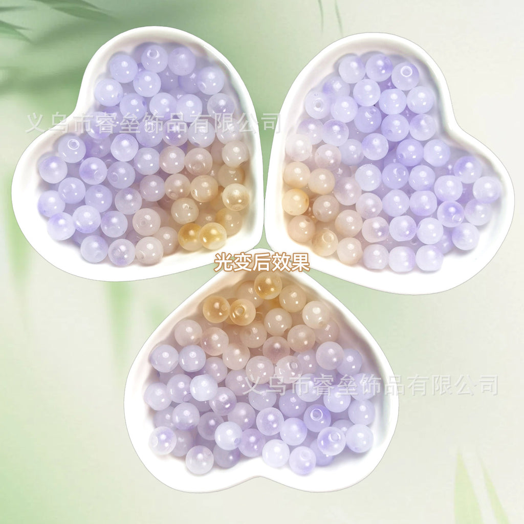 Three heart-shaped dishes of beads shifting from lavender to champagne gold