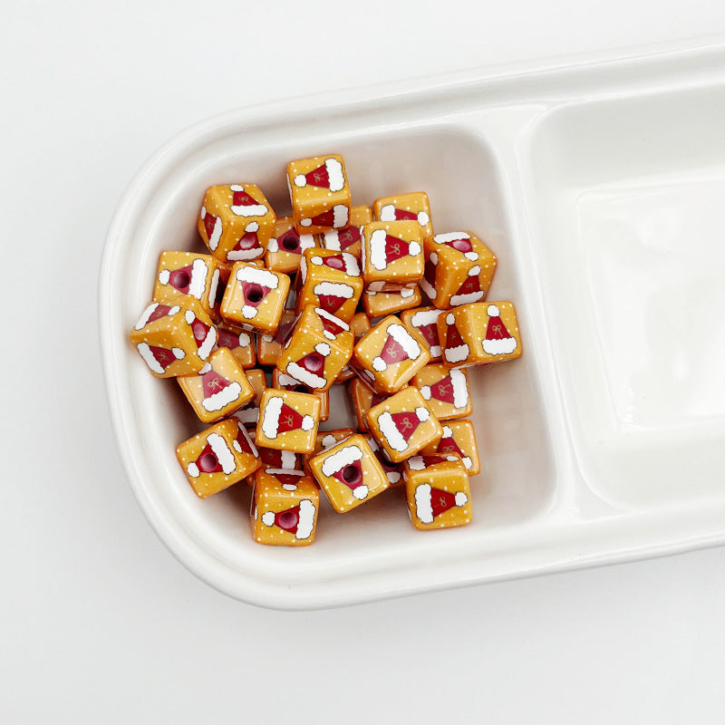Orange square beads with printed Santa hat designs in a white divided tray