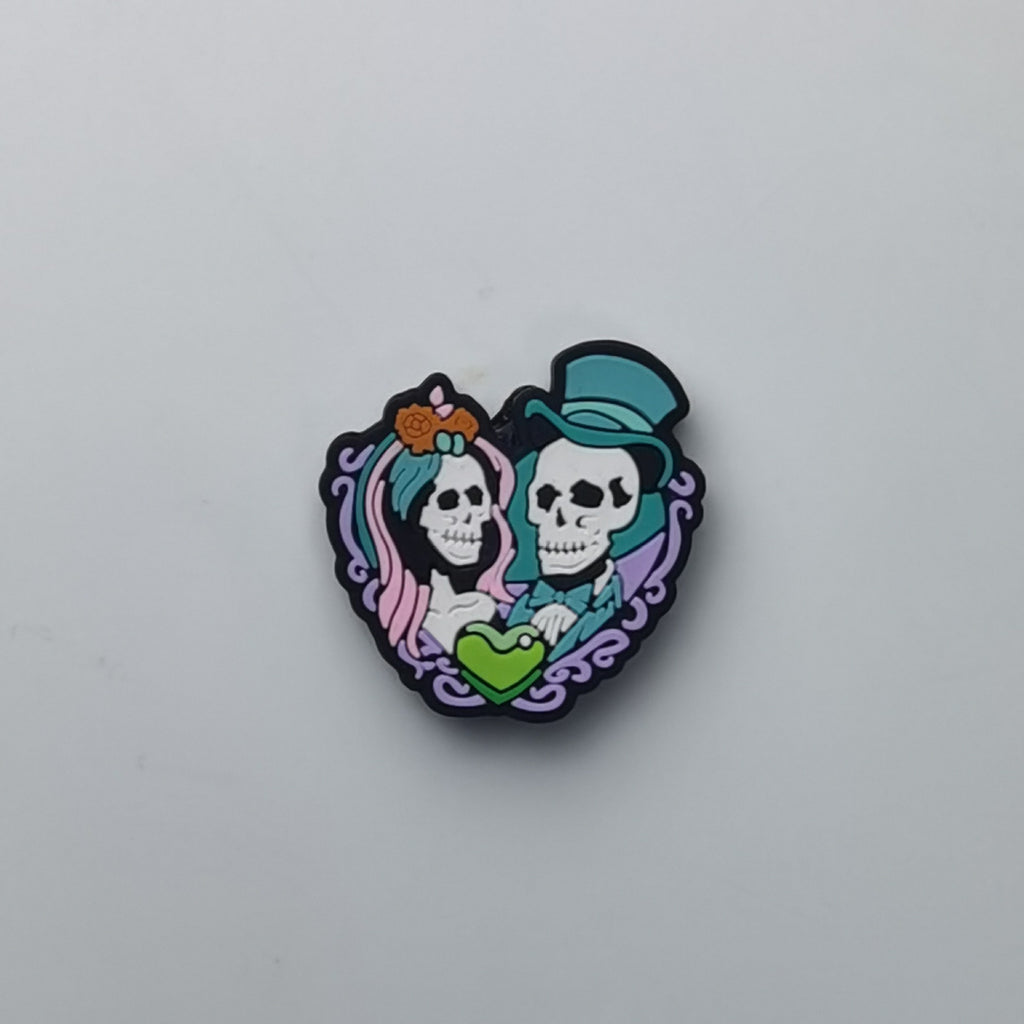 Heart-shaped bead with wedding skull couple and green heart