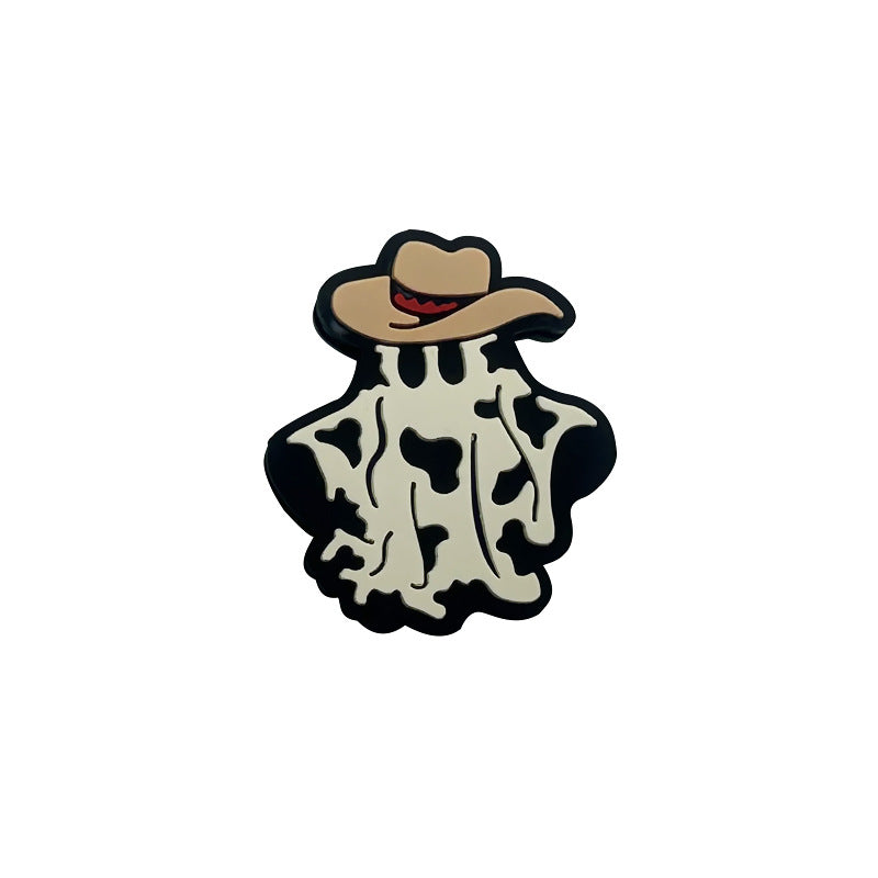 Ghost-shaped silicone focal bead with black and white cow print wearing a tan cowboy hat with red band on white background.