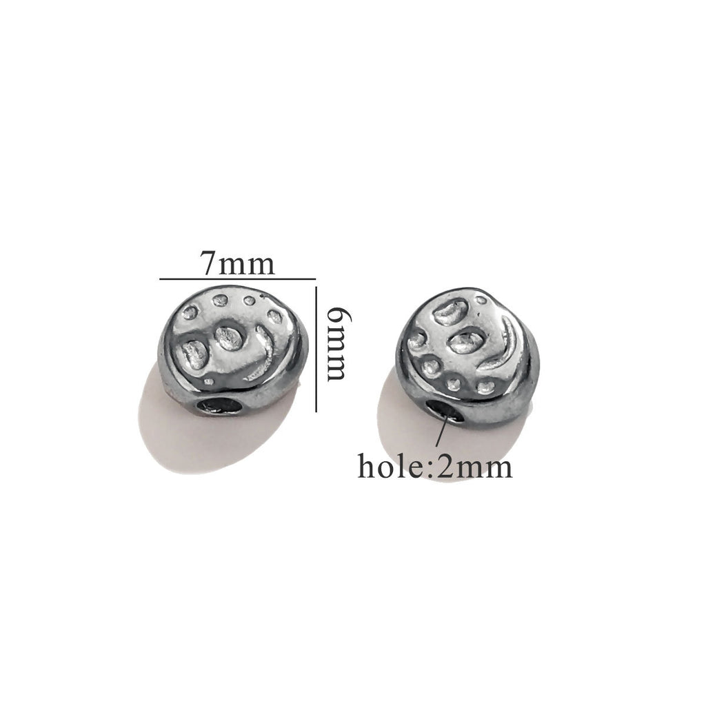 Two steel-color round baroque bead charms with textured details and dimension markings