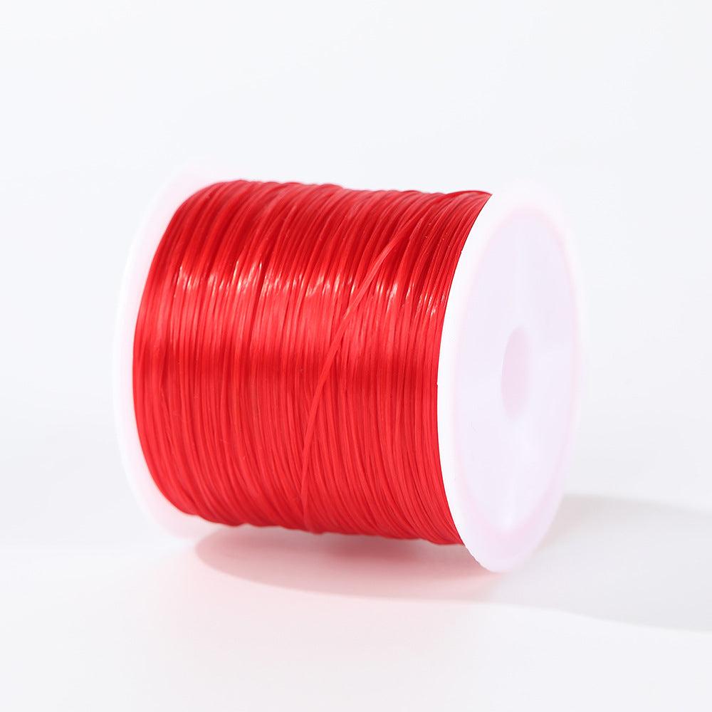 Spool of bright red 0.8mm flat elastic beading cord wound on a white plastic spool, white background