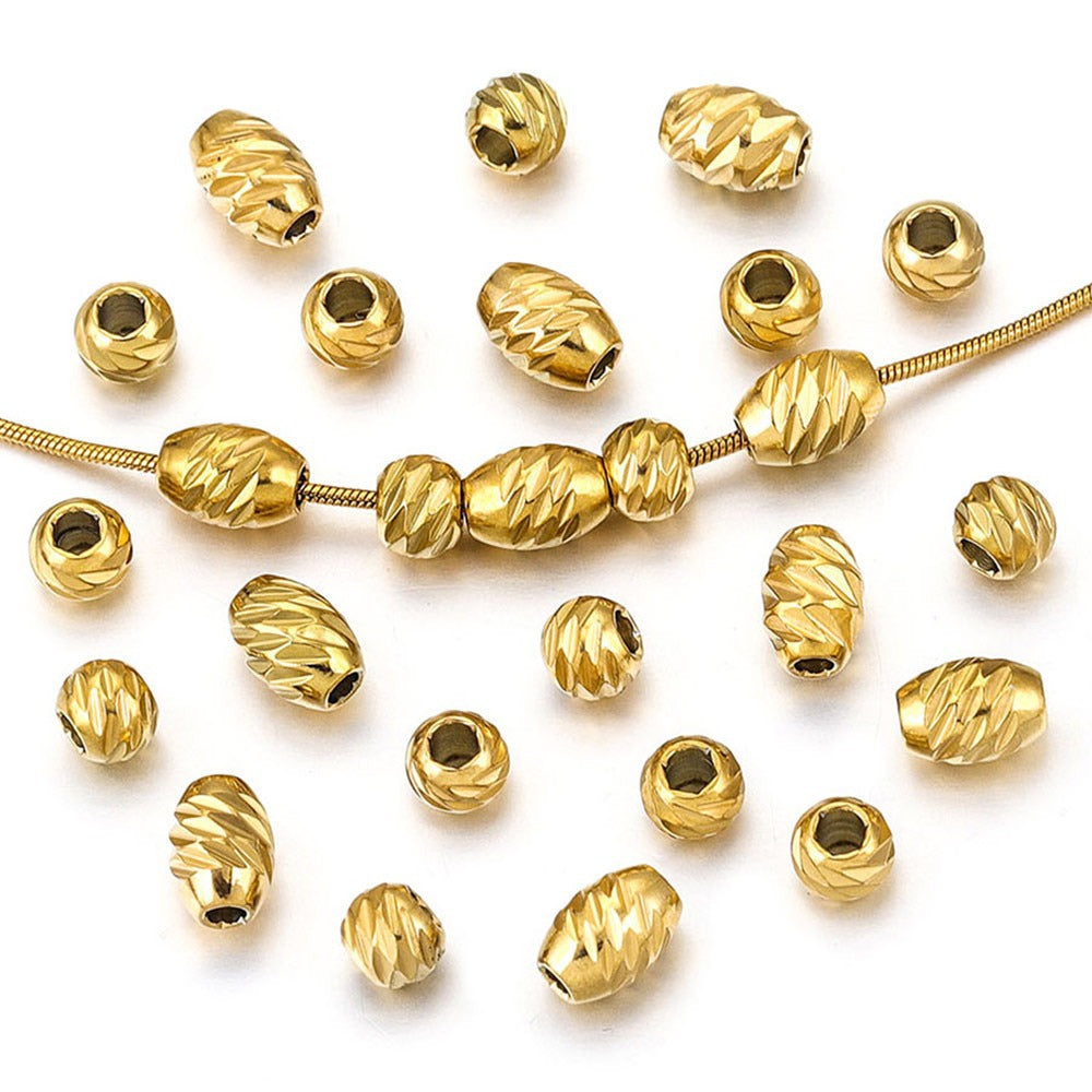 Gold-plated diamond-cut stainless steel wheel spacer beads with a snake chain on white background