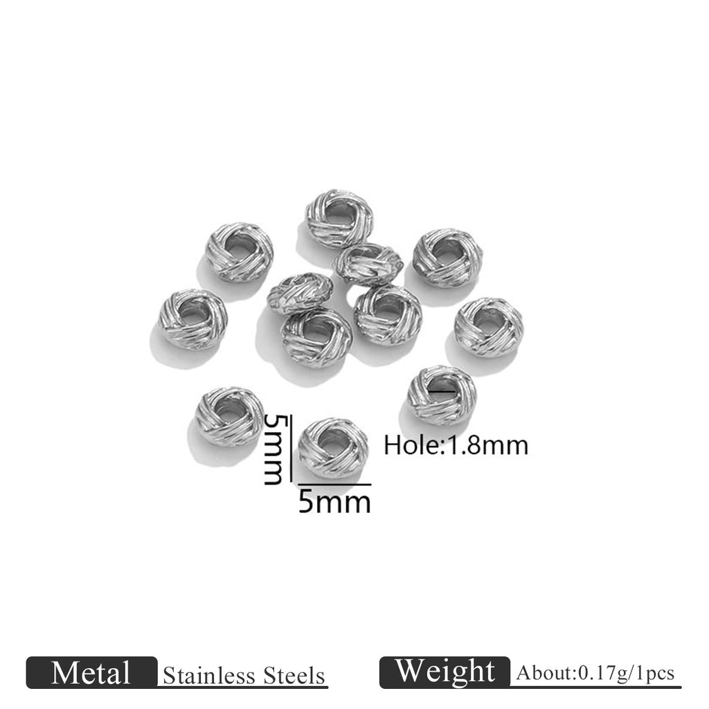 Silver stainless steel twisted bird's nest beads on a white background