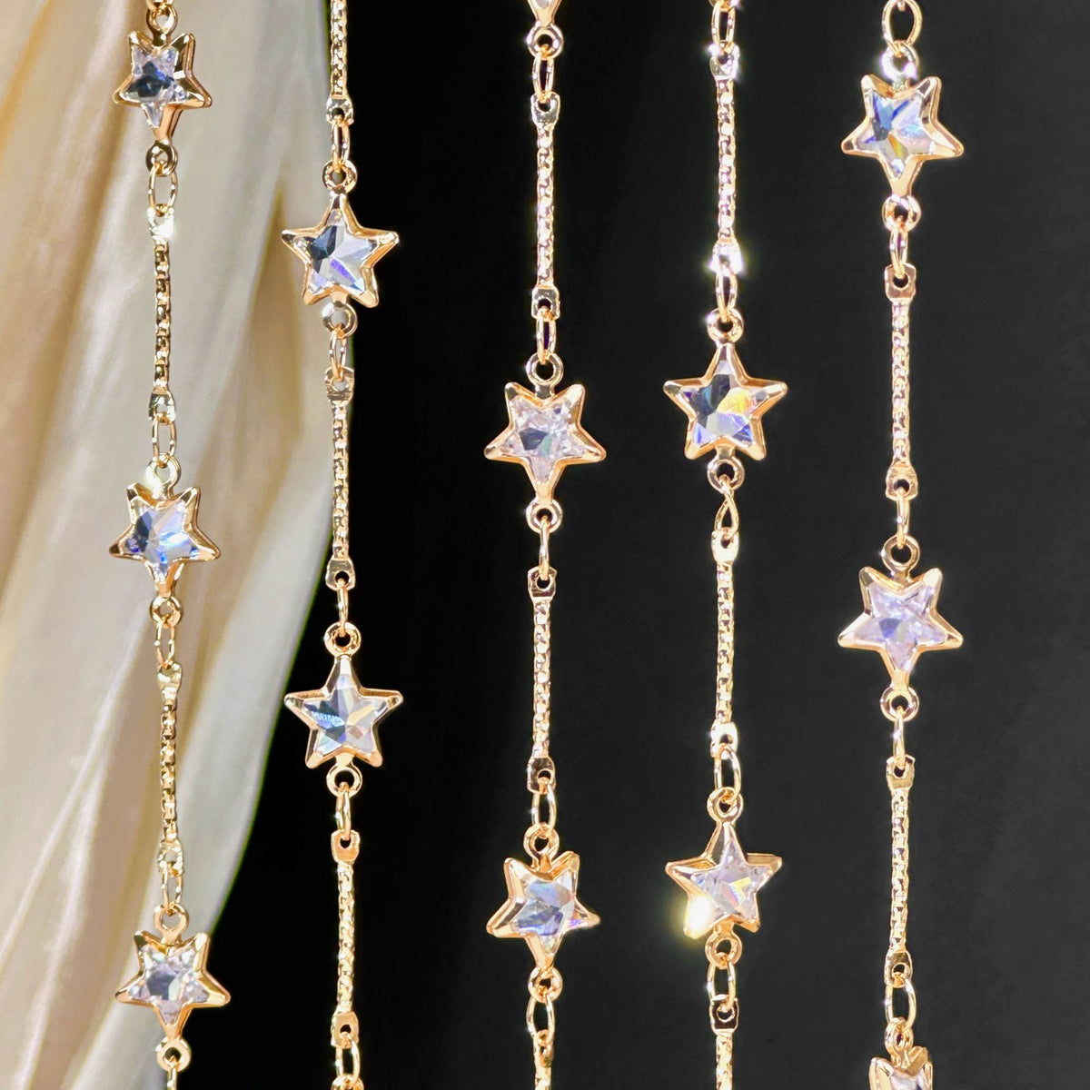 Gold-toned chain curtain with hanging star-shaped crystal beads