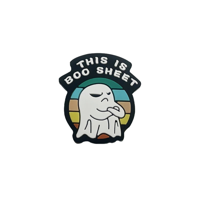 White ghost silicone focal bead with This is boo sheet text on a black arch over a retro rainbow background.
