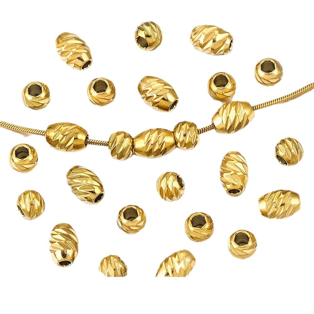 Gold-plated diamond-cut stainless steel wheel spacer beads with a snake chain on white background