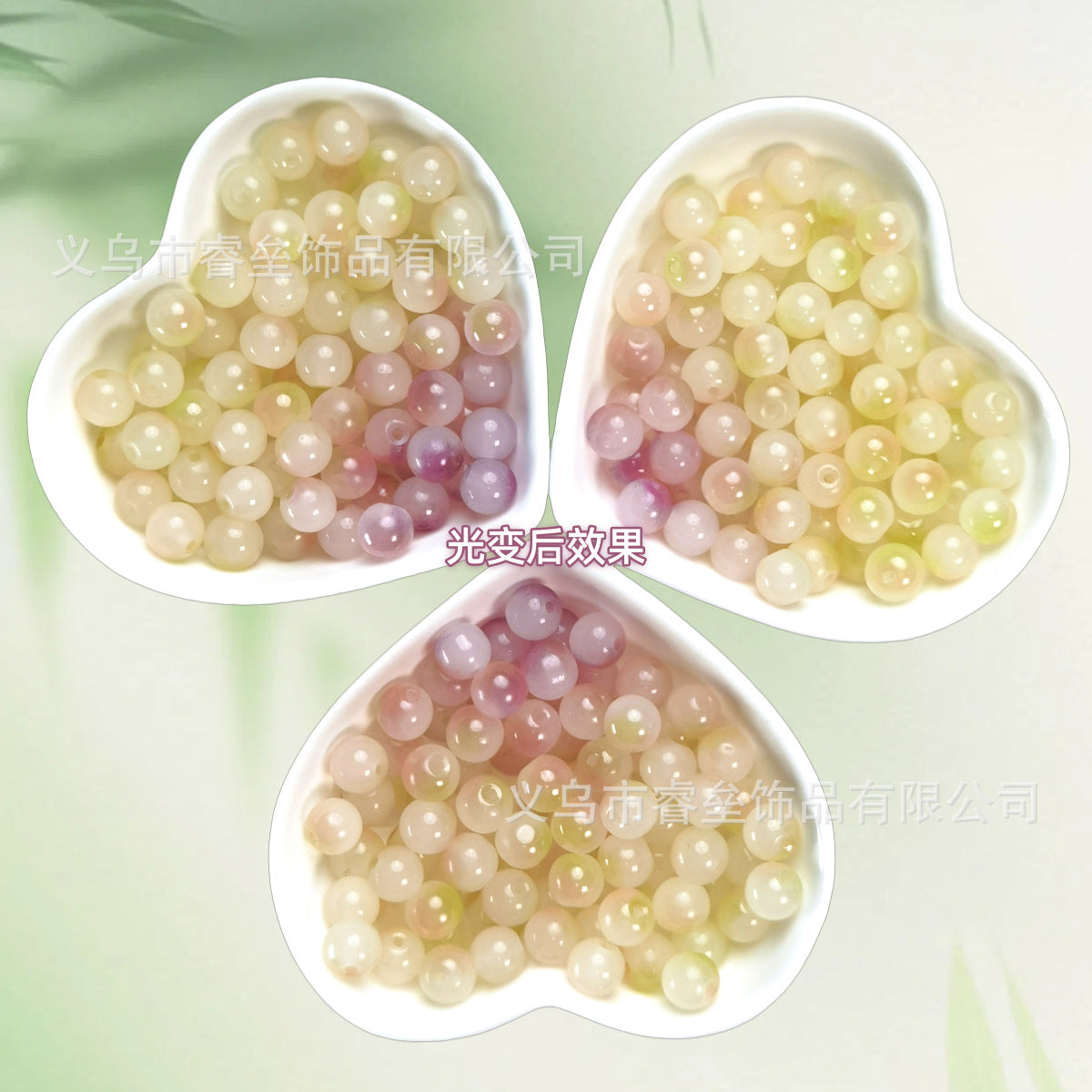 Three heart-shaped bowls of pastel cream, yellow, pink, and lavender beads on pale green