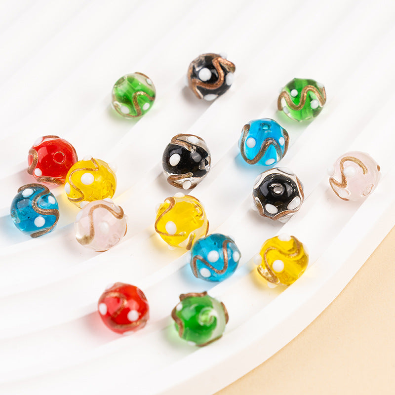Colorful gold-sand swirl glass beads with white polka dots