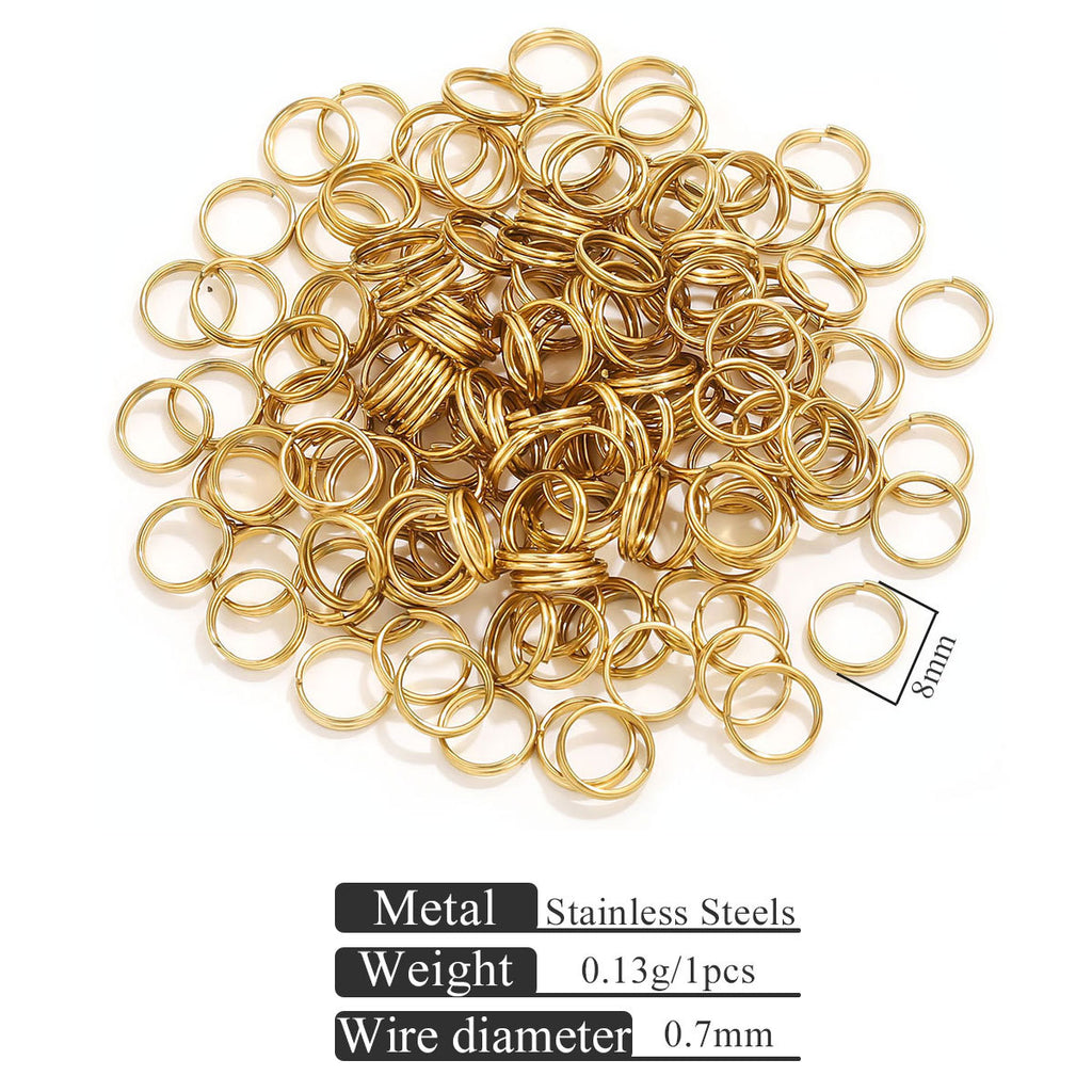 Small gold-colored stainless steel jump rings on white with size reference