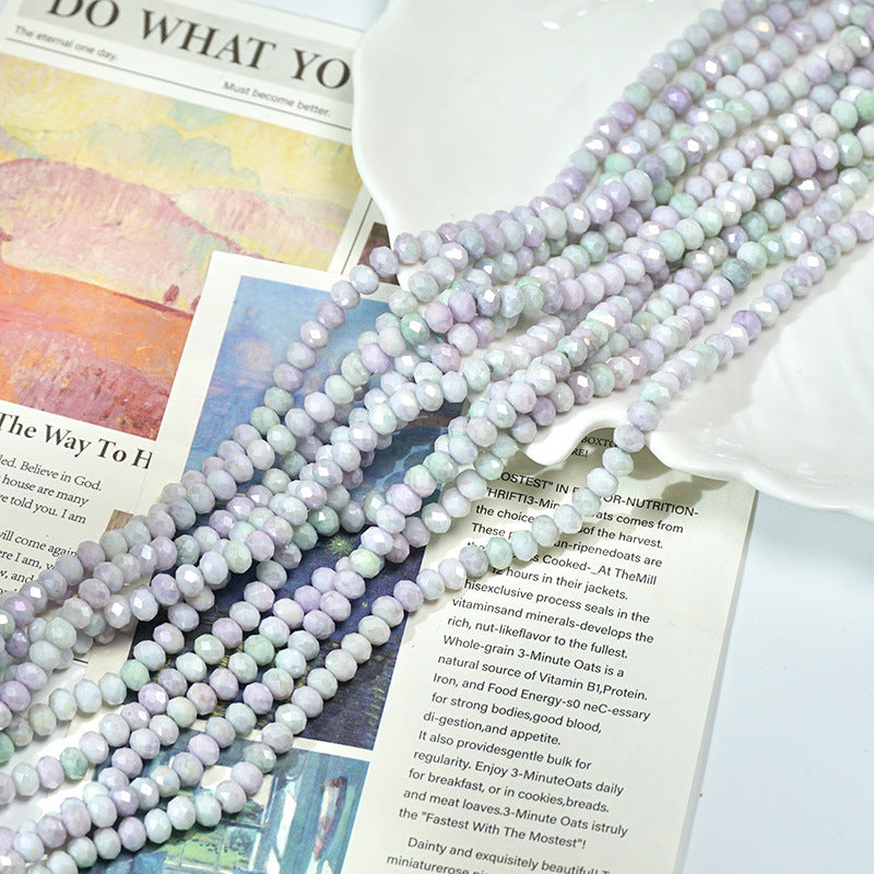 Multiple strands of pastel faceted porcelain beads in lavender, mint green, and pale blue