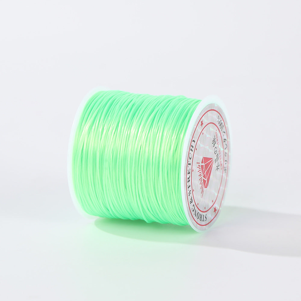 Spool of fluorescent green 0.8mm flat elastic beading cord shown at an angle, diamond label visible, white background