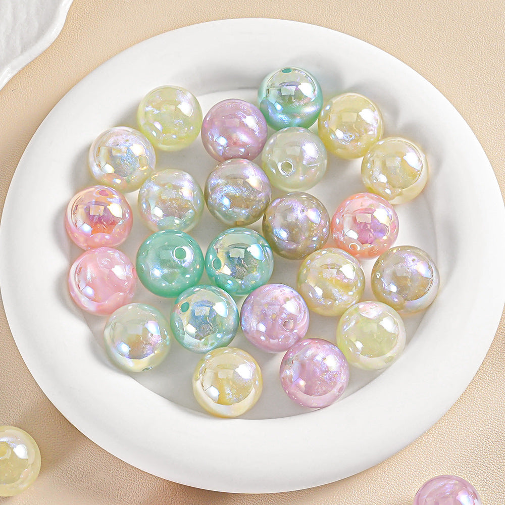 Group of iridescent glass beads in pastel pink green yellow blue