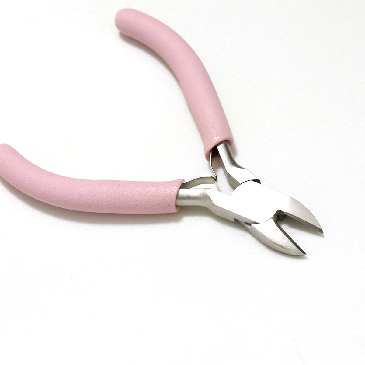 Pink-handled metal wire cutters on a plain white background.