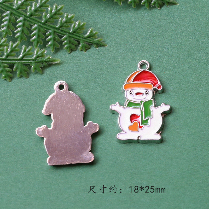 Two small hanging charms on green background, plain metallic silver