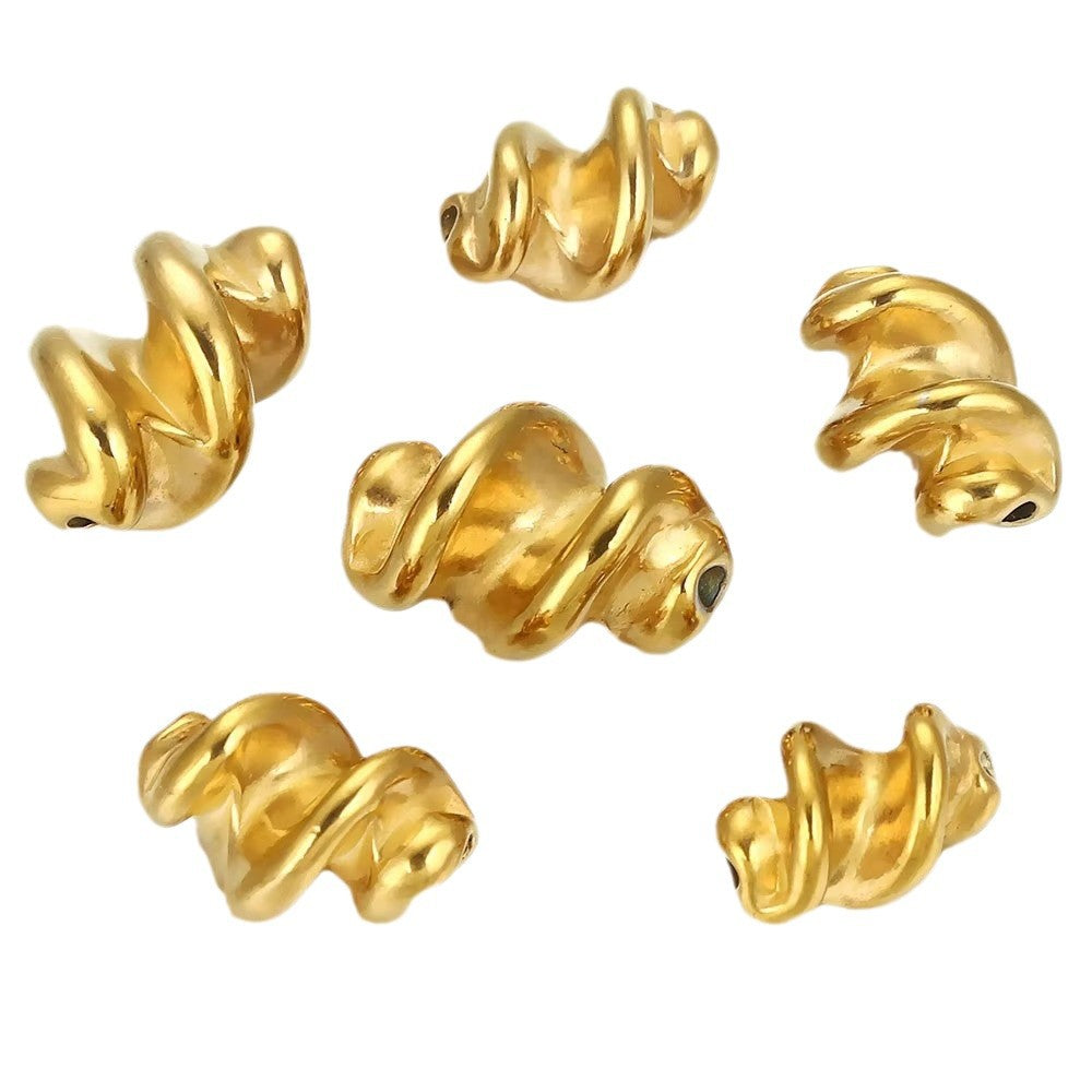Five gold twisted spiral stainless steel spacer beads on white background