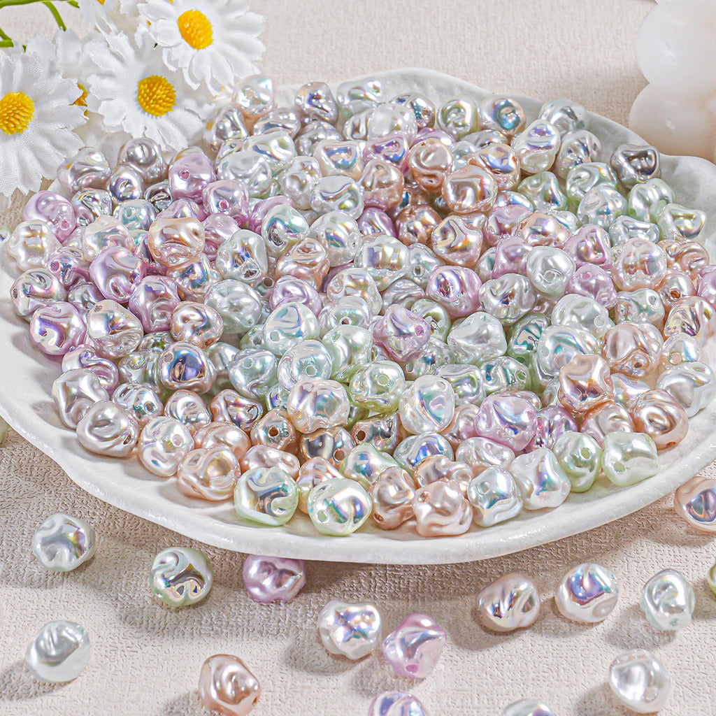 A plate piled with iridescent baroque faux pearl beads in pastel pink, green, blue and white