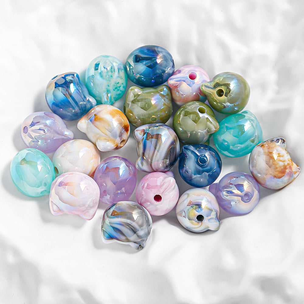 Iridescent cat head focal beads with marbled blue swirls.