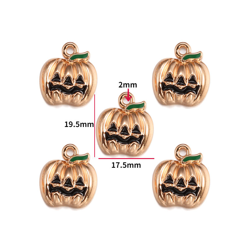 Five pumpkin-shaped charms with a gold-tone finish, black engraved facial features, and a small green stem, shown on a white background with red dimension lines and text indicating 19.5mm height, 17.