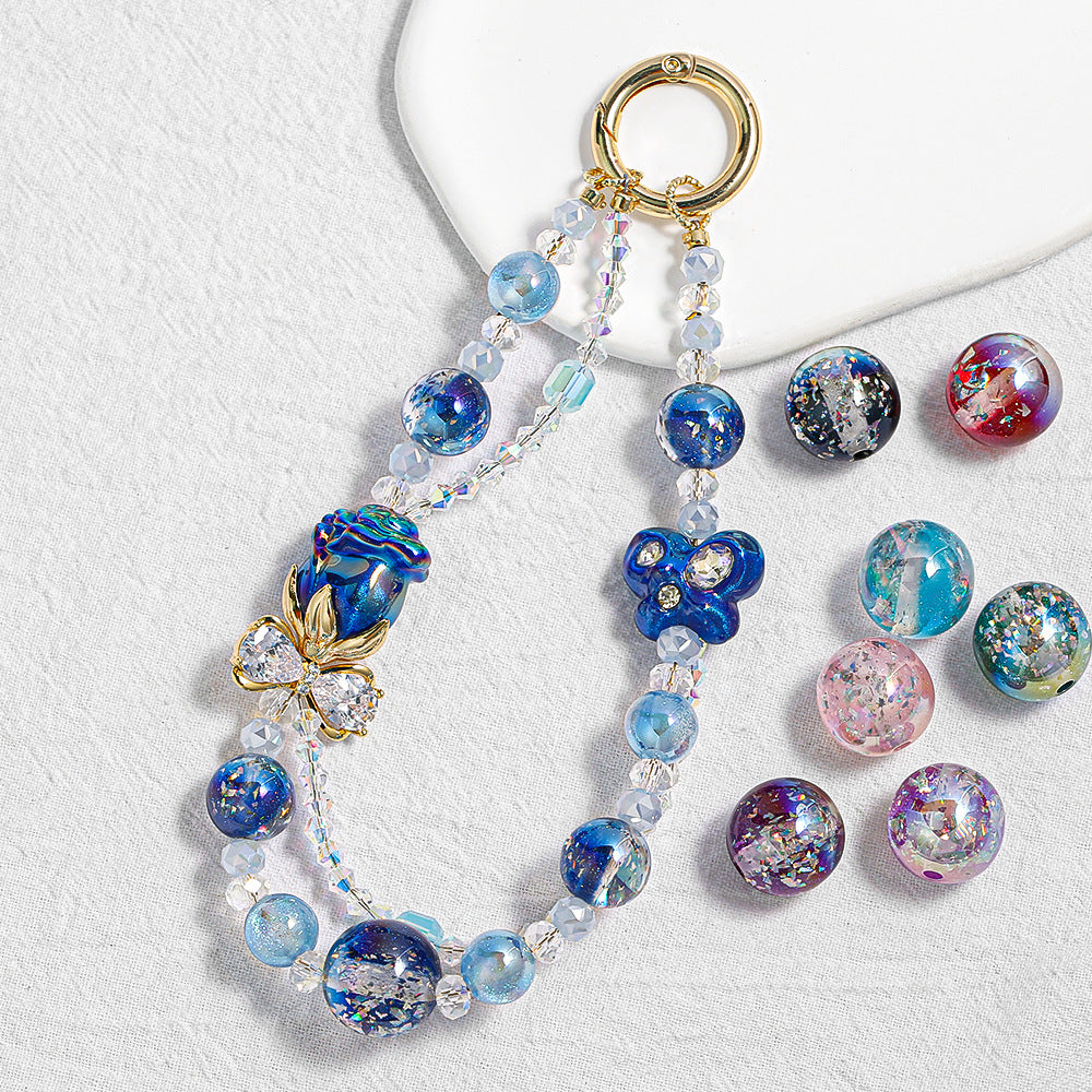 Beaded phone charm keychain with blue two-tone gradient resin beads and gold ring on white