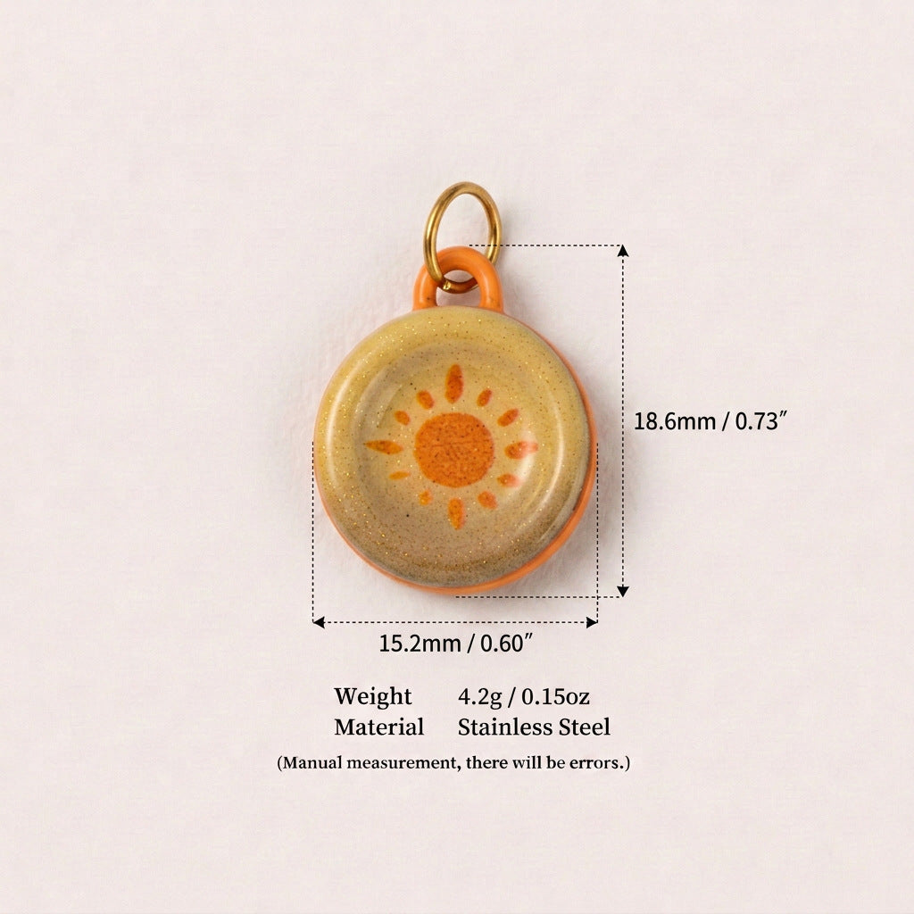 Round cream pendant charm with orange sun design, shown with size measurements.