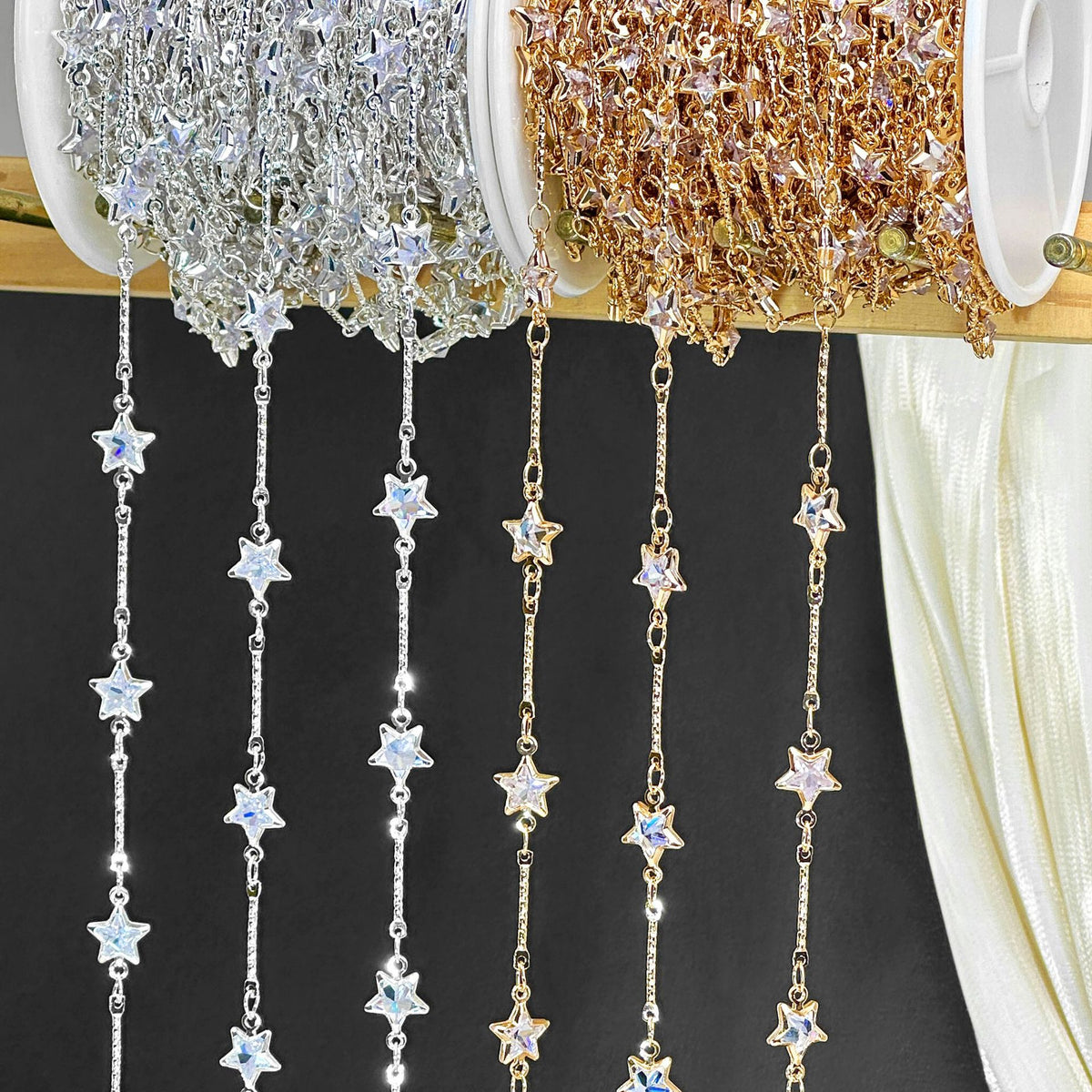 Two spools of silver-tone and gold-tone crystal star dangle chain