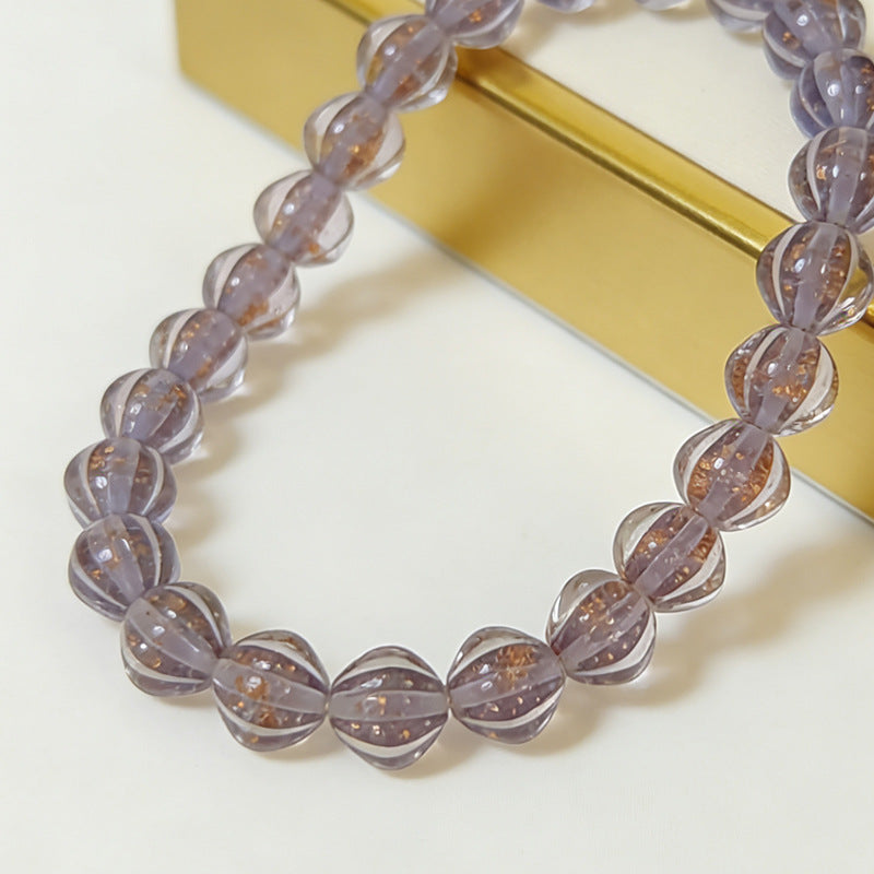 Stretch bracelet of translucent purple lantern glass beads with gold glitter