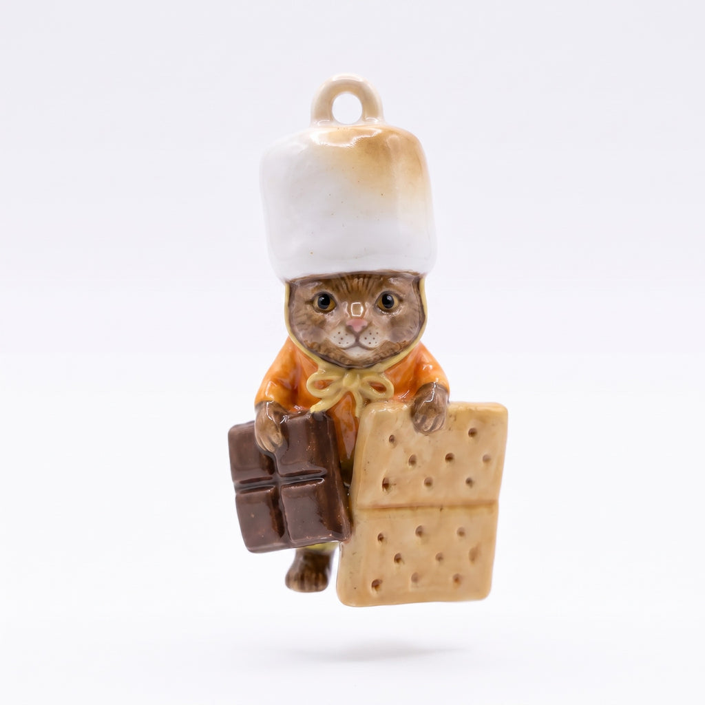 3D kitten pendant charm dressed as s'mores master, wearing orange shirt.