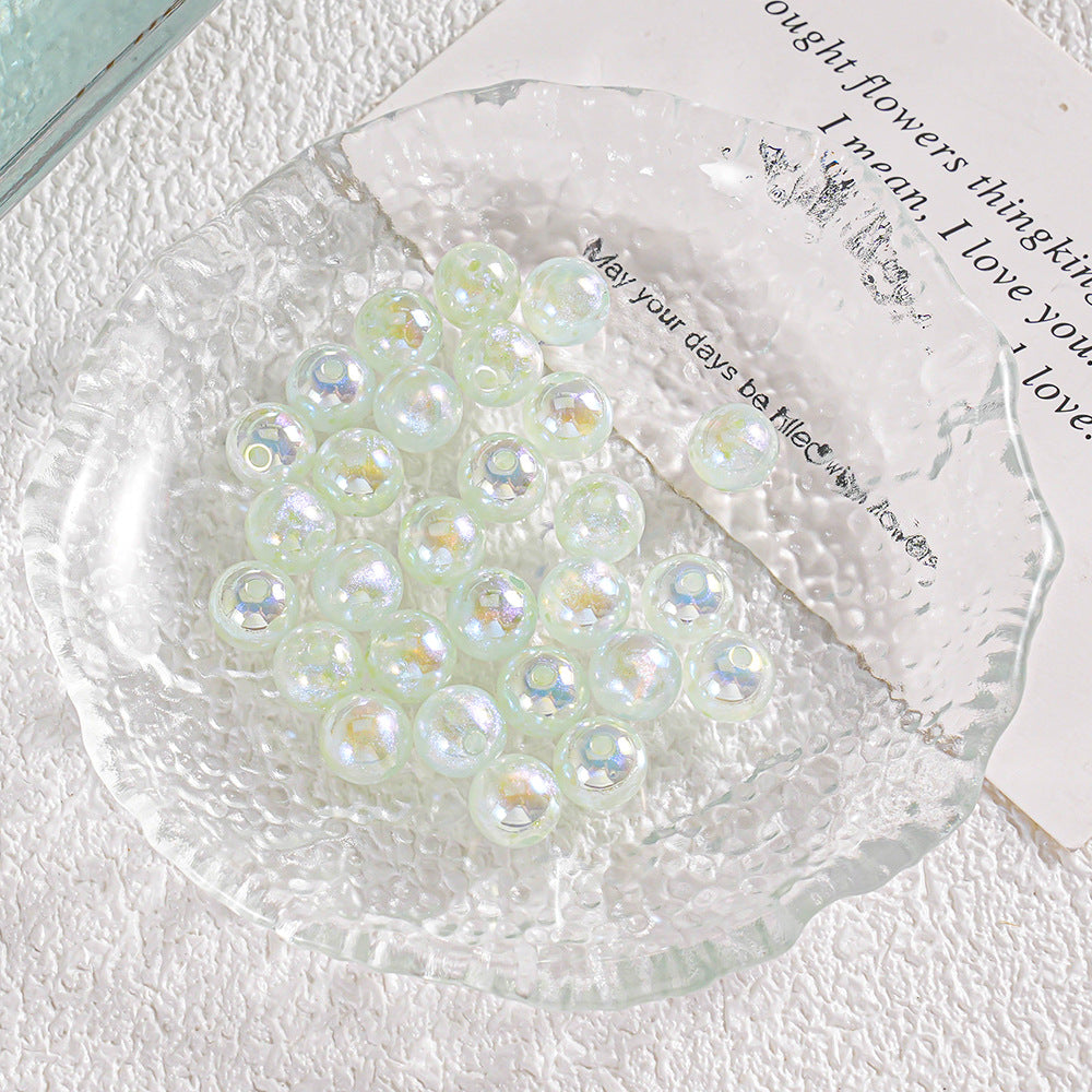 Cluster of round iridescent glass beads with small gold foil accents